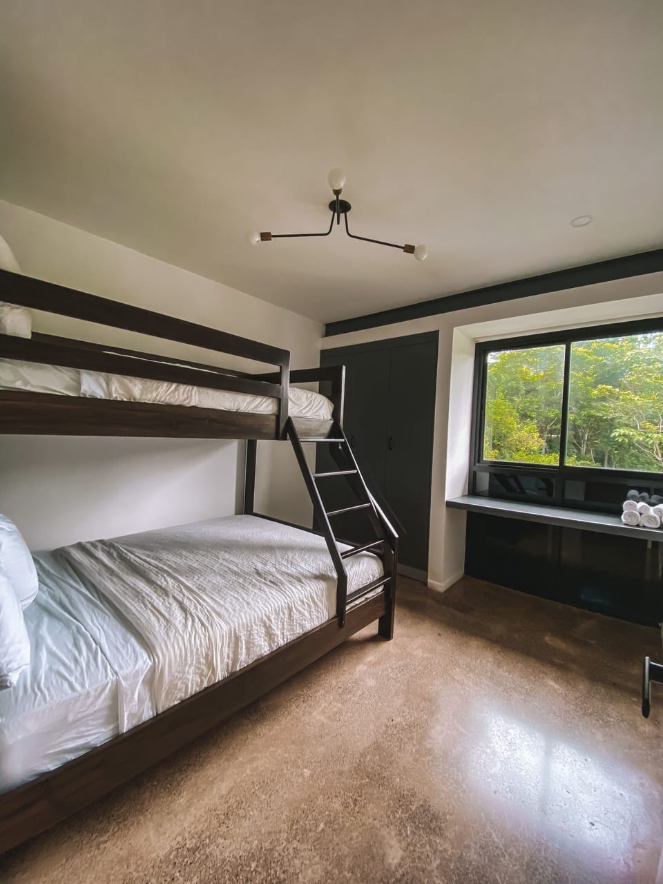 The third bedroom features a twin over queen bunk bed and workspace.