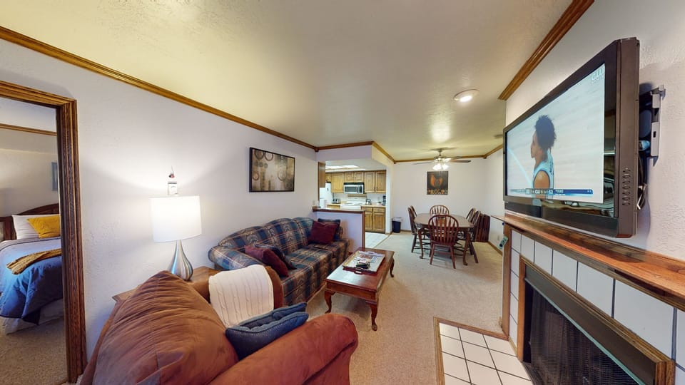 Kitchen, living room & dining area. sofa sleeps 2 of the 6 guests. fireplace etc