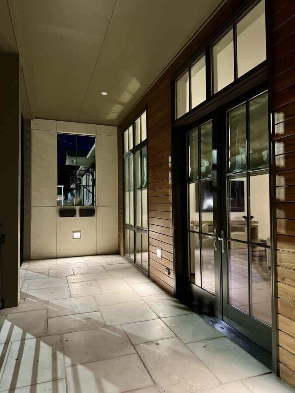 An architectural view of the tiled outdoor terrace area highlighting the transition between indoor and outdoor spaces.