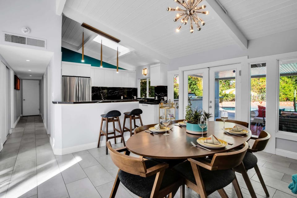 Dine in style in this elegant dining room featuring a beautifully crafted table for six, a sparkling crystal chandelier, and a cozy fireplace. The space creates a warm and inviting atmosphere perfect for family meals or elegant dinner parties. Salut!