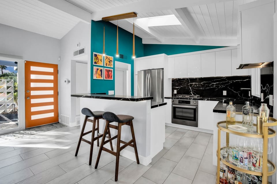 Gather around the stylish kitchen bar with seating for two. Featuring stainless steel appliances, sleek countertops, and ample cabinet space, it's the perfect space to cook and gather with family and friends, creating delicious memories together.