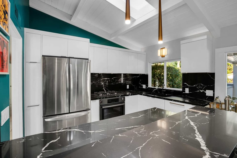 Gather around the stylish kitchen bar with seating for two. Featuring stainless steel appliances, sleek countertops, and ample cabinet space, it's the perfect space to cook and gather with family and friends, creating delicious memories together.