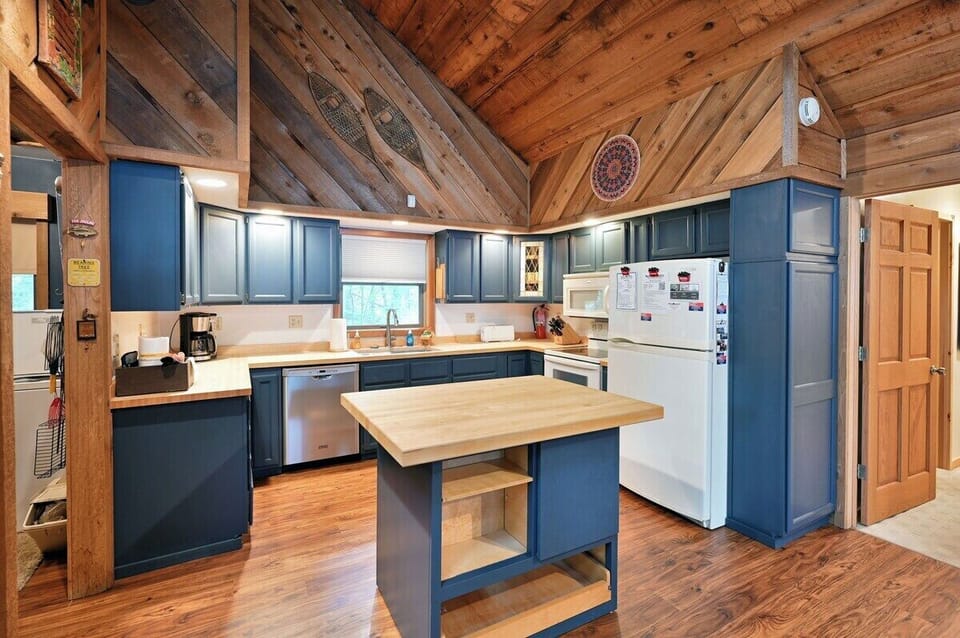 The well appointed kitchen has a full size refrigerator, dishwasher, stove, oven, pots, pans, utensils, and dishes.