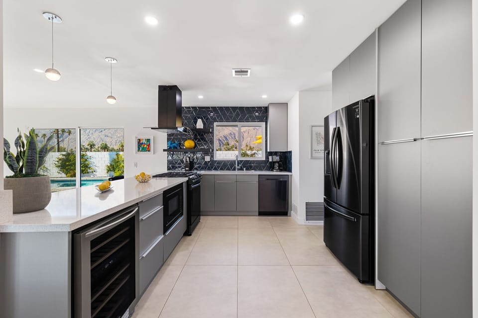 Fully equipped modern kitchen with premium appliances and a wine chiller.