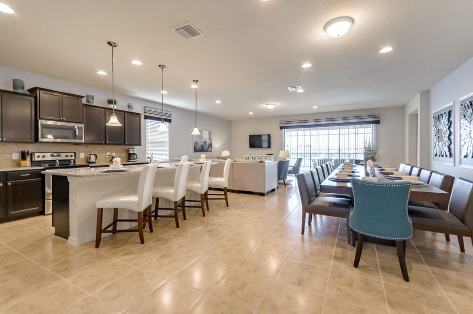 Spacious Downstairs Area Including Full Size Kitchen, Dining Table, and Comfortable Seating