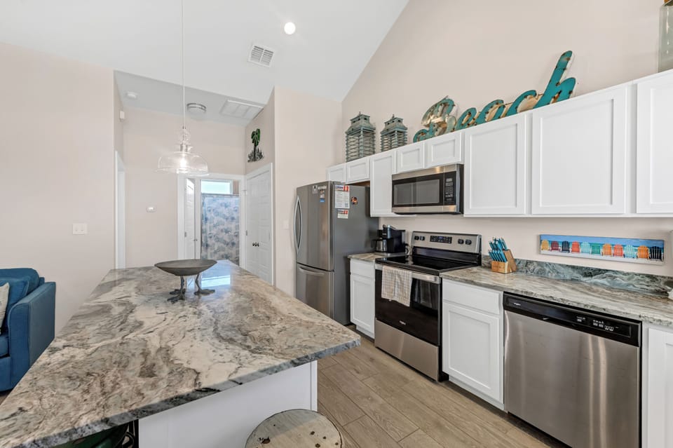 Your fully equipped kitchen awaits with granite counters, stainless appliances, and everything you need to create memorable vacation meals.