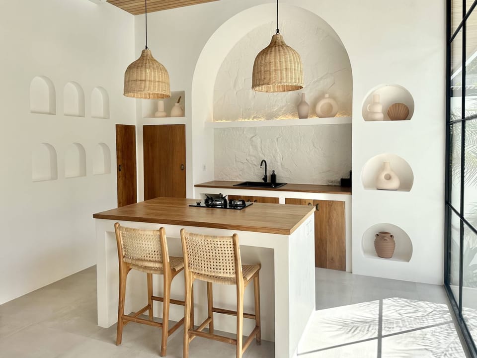 Kitchen with a stove, oven, fridge, and a water dispencer