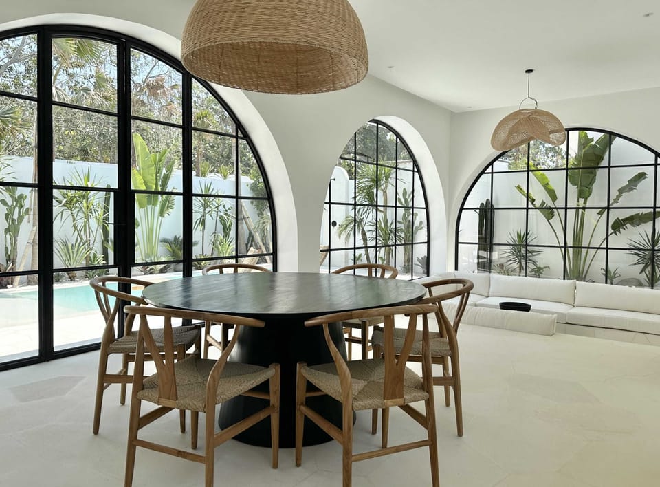 Large dining area and a living room with a poolside view