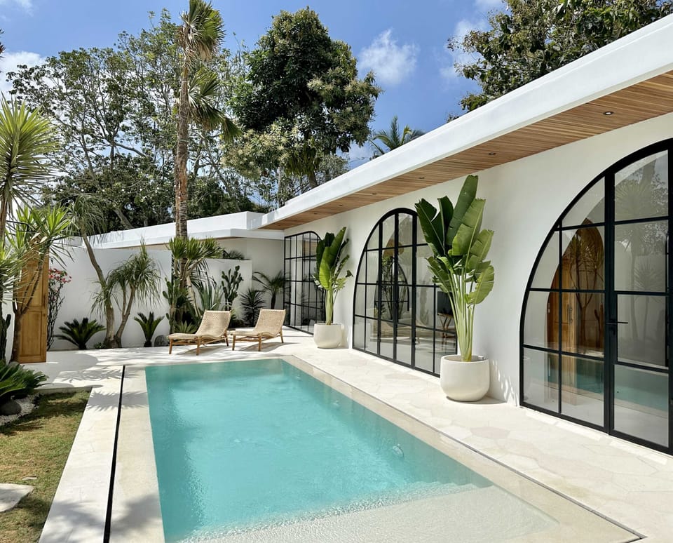 Outdoor area with a swimming pool and two lounge chairs