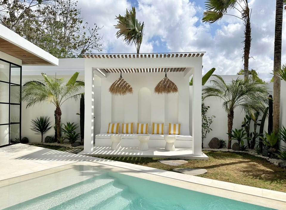 The shaded outdoor lounge with cushions and terrazzo tables