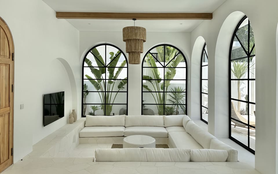 White sunken lounge in the living room with a smart Tv