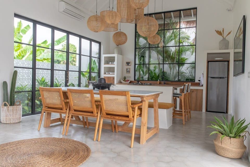 Our kitchen bar with integrated seating and white marble top dining table.
