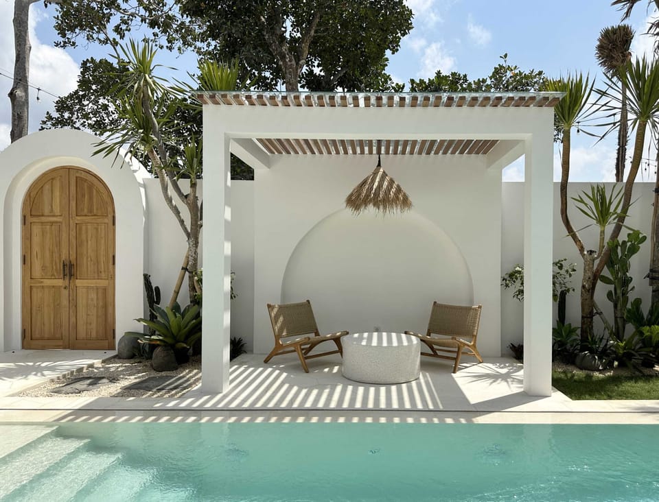 An outdoor lounge with two chairs and a terrazzo coffee table