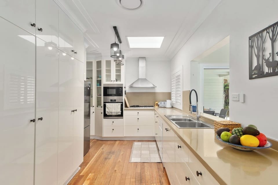 An oversized kitchen comes fully equipped for your holiday catering with modern appliances and ample bench space.