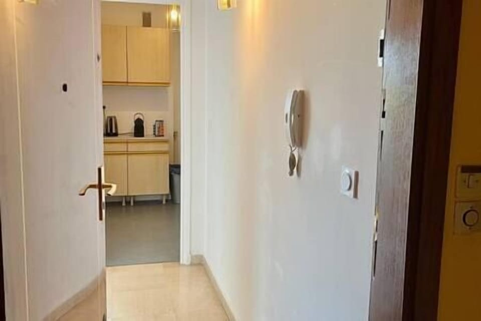 Entrée du logement avec le couloir accédant à la cuisine 