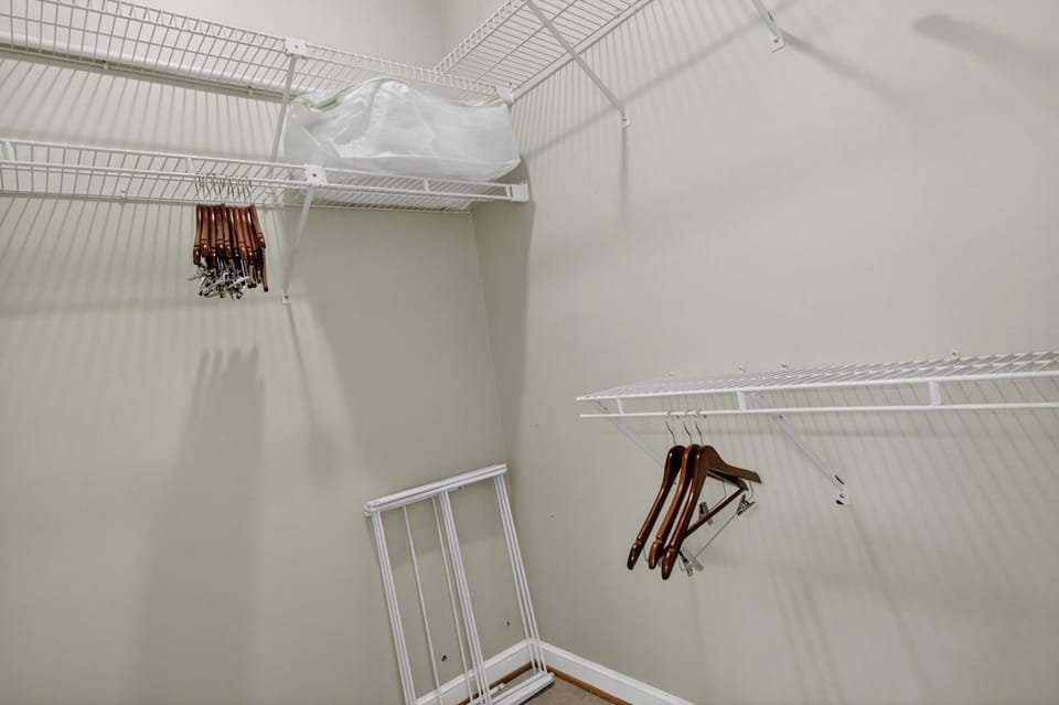Your walk-in closet offers generous storage with wire shelving and hanging space to keep your belongings organized during your stay.