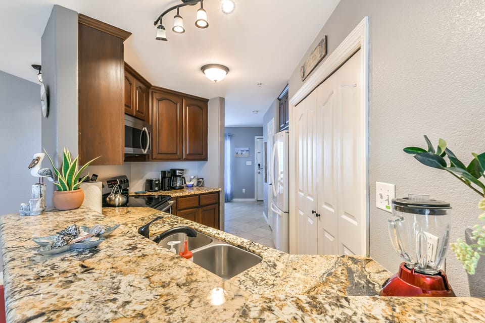 A WASHER AND DRYER ARE LOCATED IN THE KITCHEN AREA CABINET