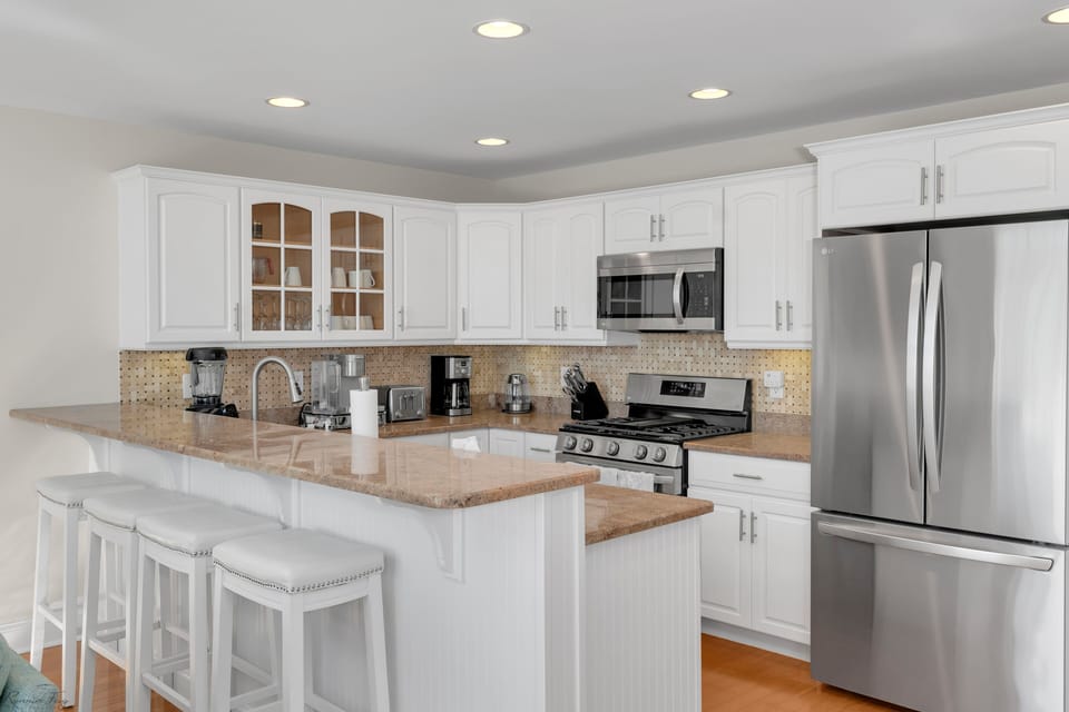 Fully stocked kitchen with complete with an island seating for 4