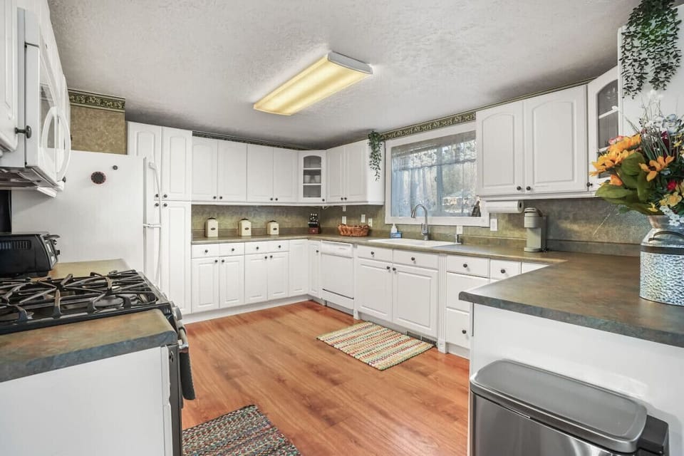 Fully-stocked kitchen with white cabinets