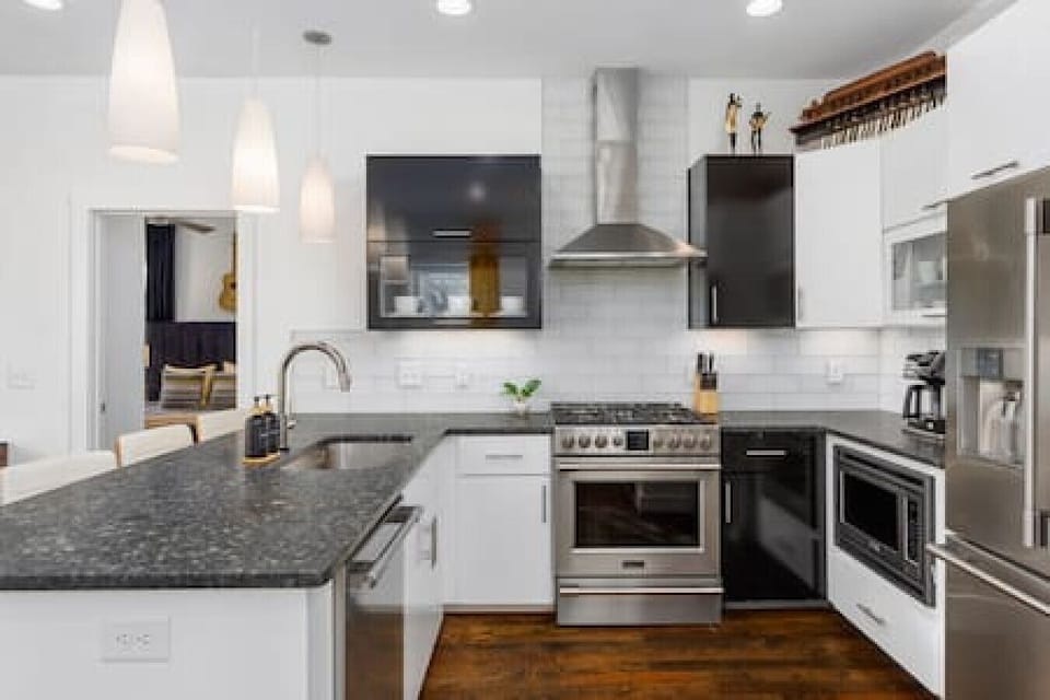 Gas range and high-end appliances in this updated, well-equipped kitchen with seating for four at the counter.