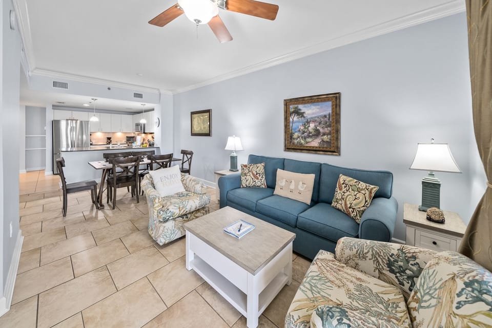 Unwind in this bright, coastal-inspired living space with comfortable seating and an open kitchen perfect for your vacation gatherings.