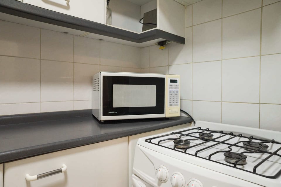 Our dedicated cooking area includes a clean, reliable stove and an accessible microwave, making meal preparation hassle-free.