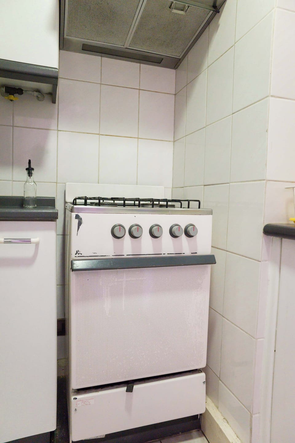 Compact kitchen with essential amenities for your culinary needs in a cozy studio apartment.