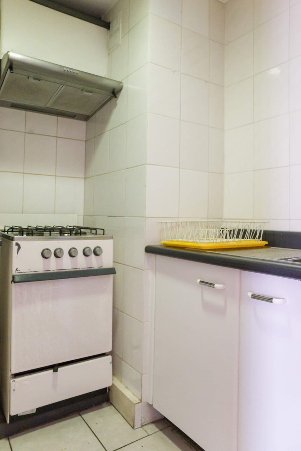 Cozy kitchen corner with essential amenities for your culinary needs in a compact studio setting.