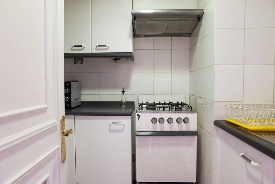 Cozy kitchen with essential appliances for a comfortable stay in the heart of the city.