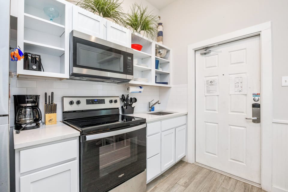 Your fully equipped kitchen invites you to whip up anything from morning coffee to gourmet meals with modern appliances and bright white cabinetry.