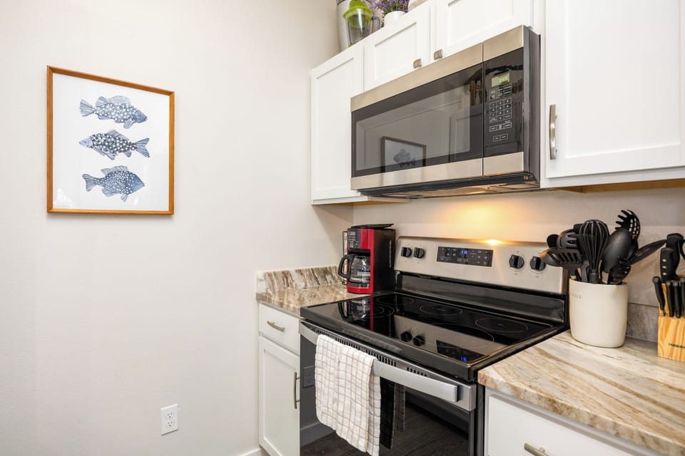Your fully equipped kitchen features modern appliances and coastal charm, perfect for preparing meals during your stay.