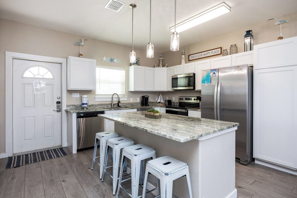 Cook your favorite meals in this bright modern kitchen with granite countertops, stainless appliances, and bar seating for casual dining.