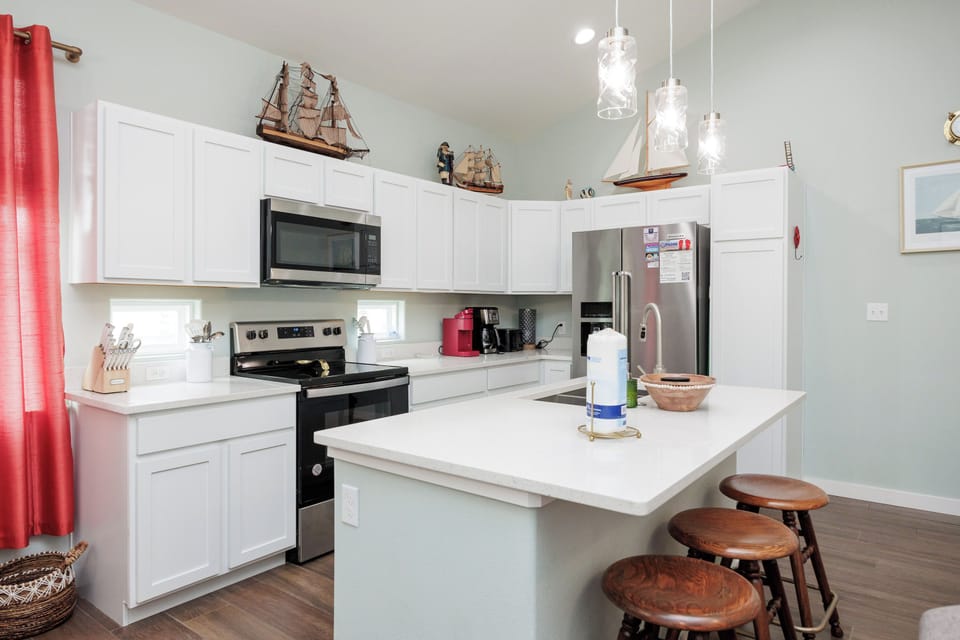 Your fully equipped kitchen features modern appliances, granite counters, and nautical touches that create the perfect space for preparing memorable meals.