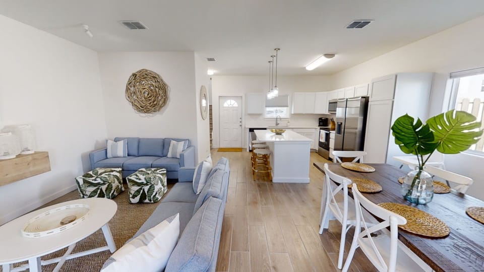 Relax in this bright open-concept space where coastal blues meet warm woods, creating your perfect home away from home.