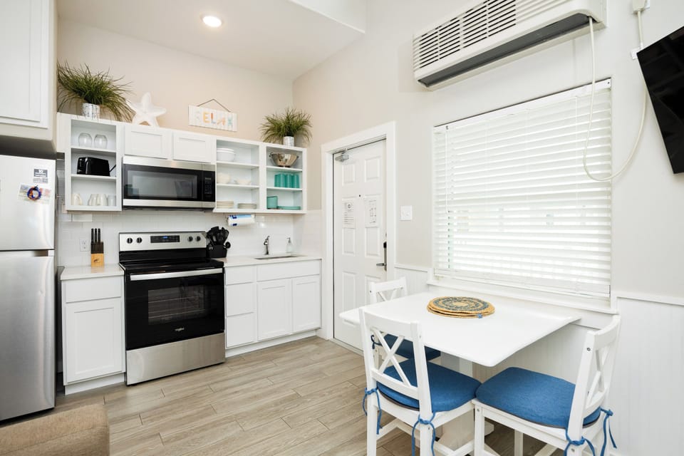 Your bright kitchen offers everything needed for vacation meals, with modern appliances, ample storage, and a cozy dining nook by the window.