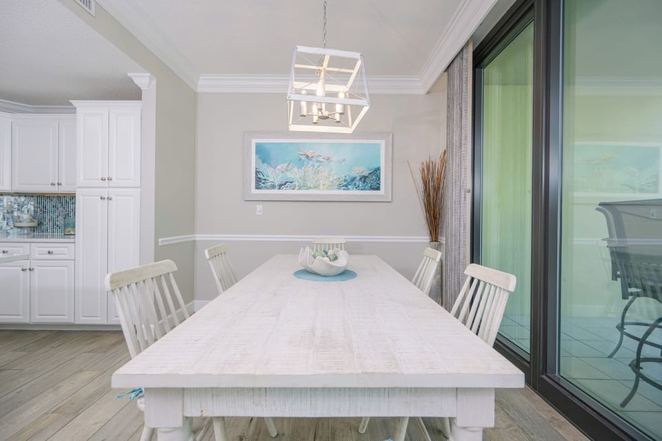 Savor a leisurely brunch at the spacious dining table while enjoying the coastal ambiance and soft lighting