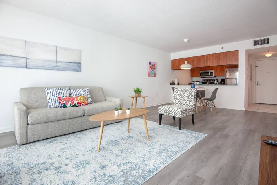 Modern open concept living space featuring a cozy queen sized sofa bed