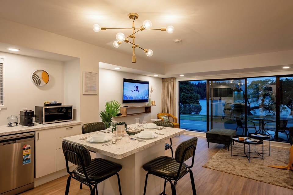 Open plan living, full kitchen, breakfast island with alps and lake views