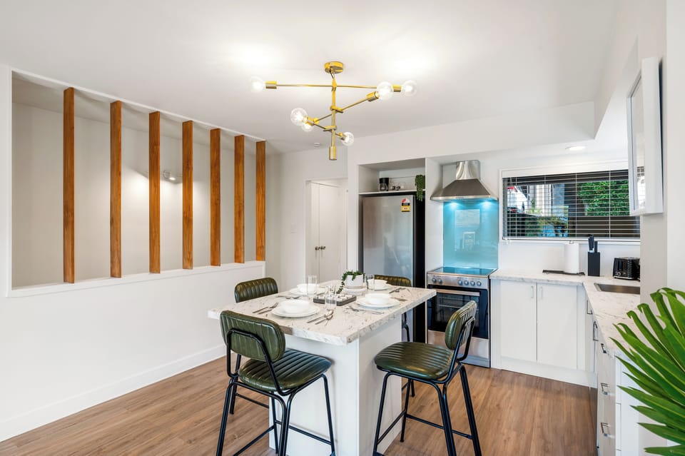 Open plan living, full kitchen, breakfast island with alps and lake views