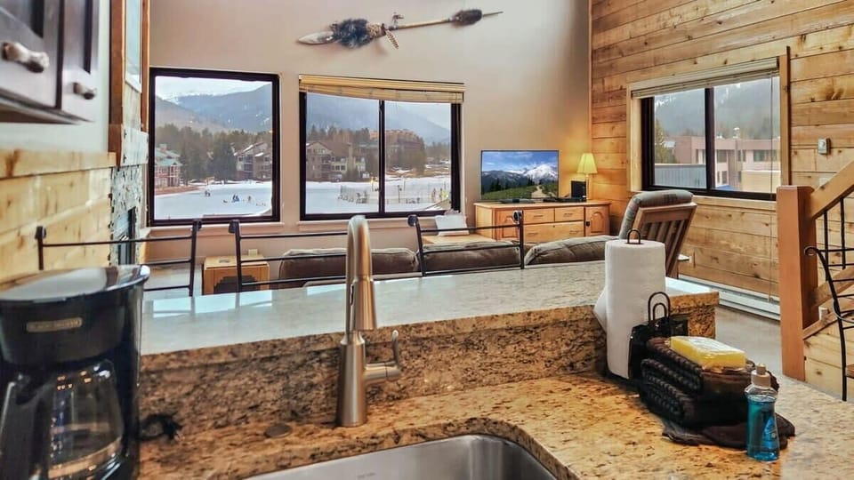 The open layout of the home makes it so you can enjoy views of the lake and mountain while you prepare meals.