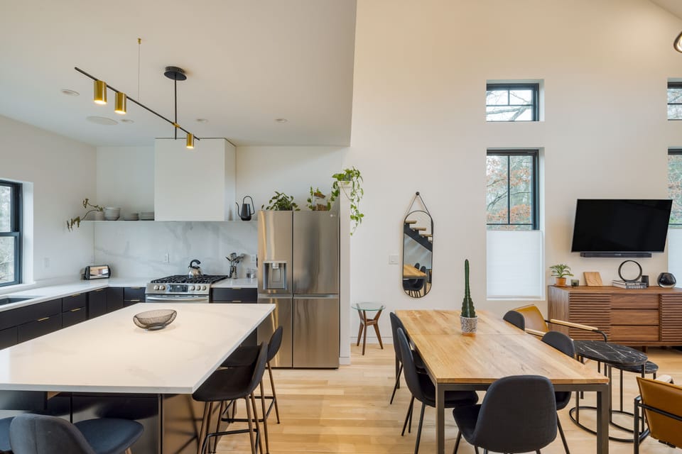 Plenty of seating for all between the dining table and additional barstool seating at the kitchen island.