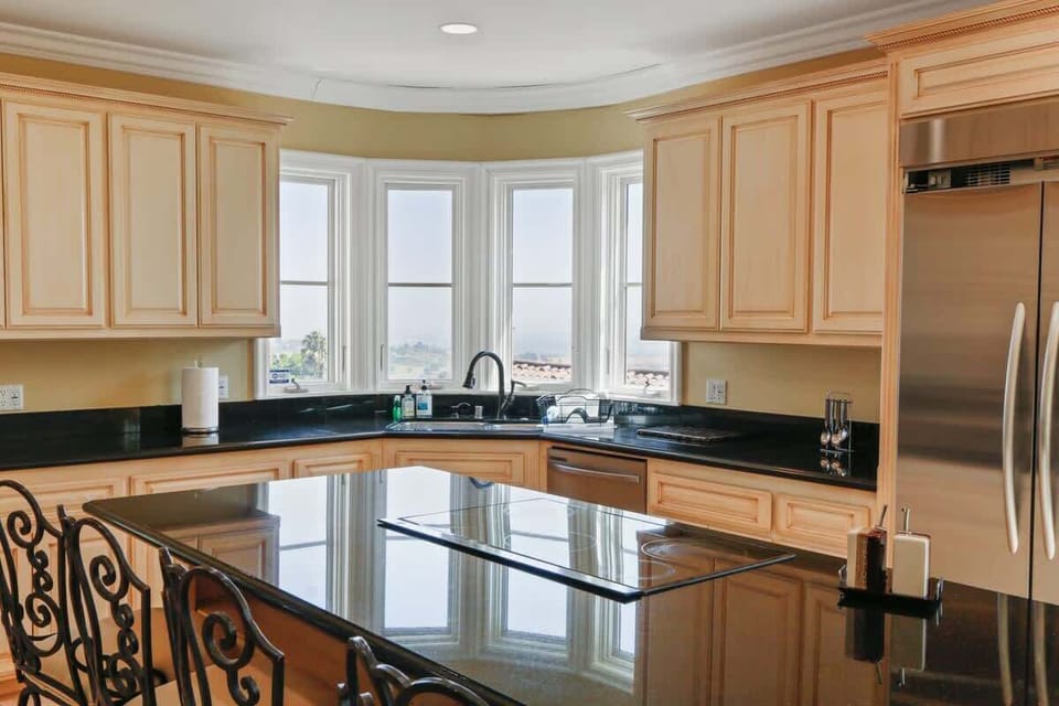 Step into a fully equipped kitchen, perfect for any culinary need. Whether it's a quick breakfast or a gourmet meal, everything is at your fingertips. Large windows fill the space with natural light, offering stunning views as you cook.