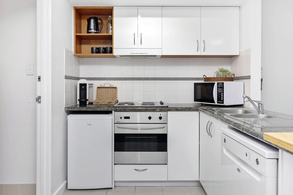 Whip up a delicious meal in this well-equipped kitchen, featuring modern appliances and ample counter space.