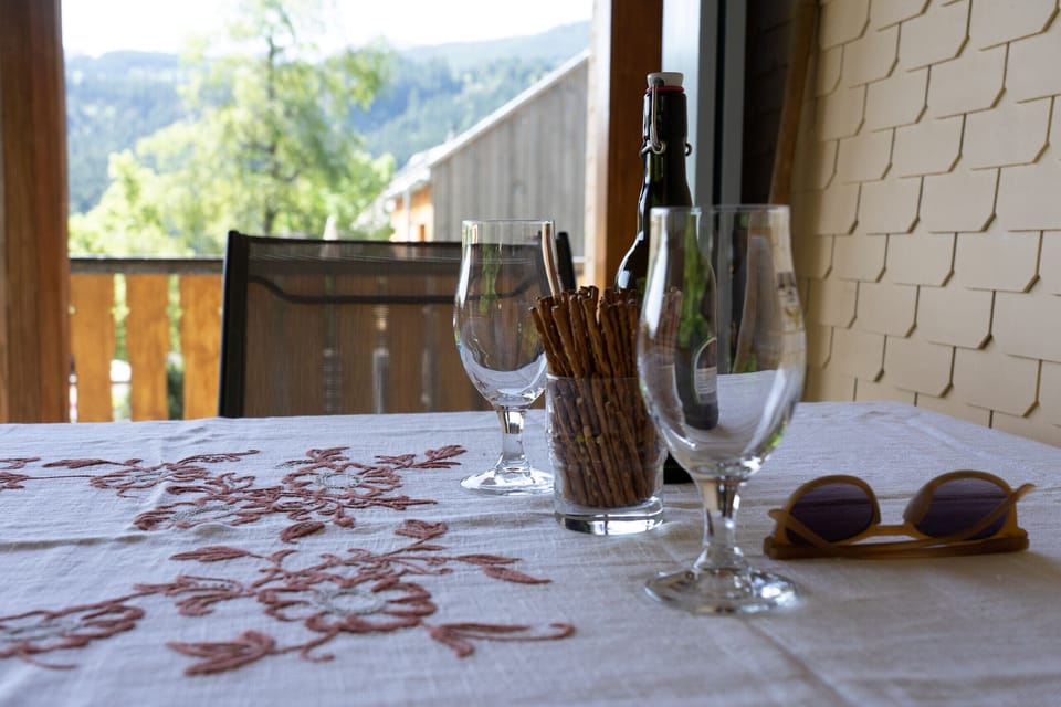A laid table with glasses and a view of the balcony