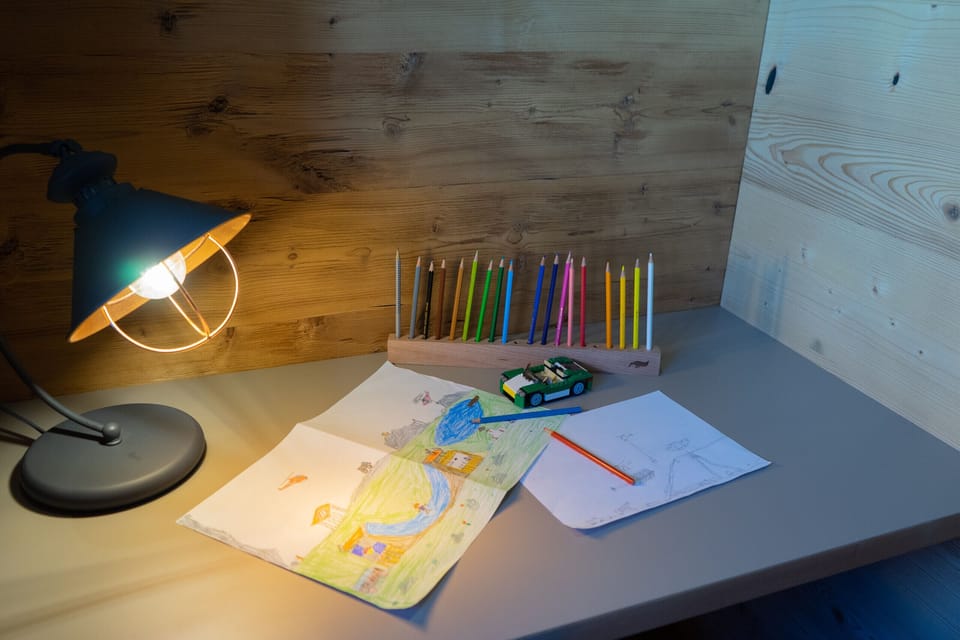 Creative corner with coloured pencils and children’s drawings