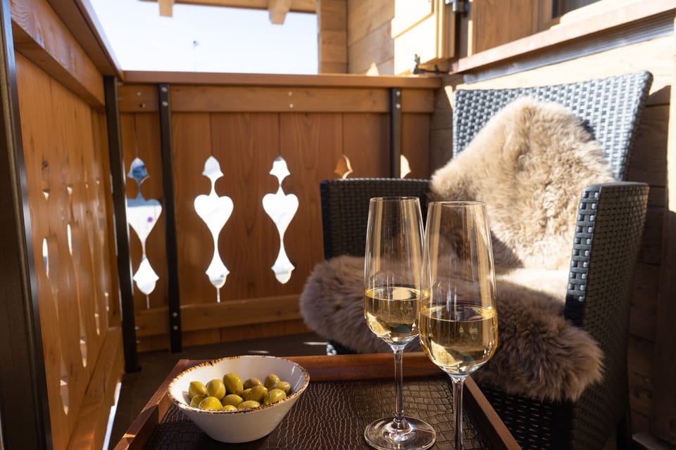 Cozy balcony seating with wine and olives