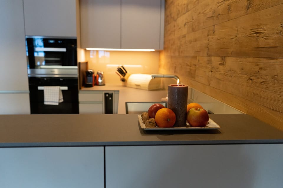 Modern kitchen with wood accents and decorative fruit plate