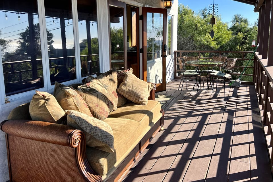 The balcony has a comfortable couch and dining for four.