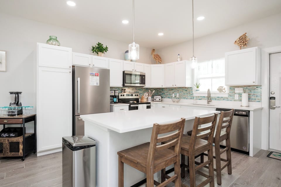 Your fully equipped kitchen features modern appliances, spacious countertops, and a breakfast bar where you can enjoy morning coffee together.