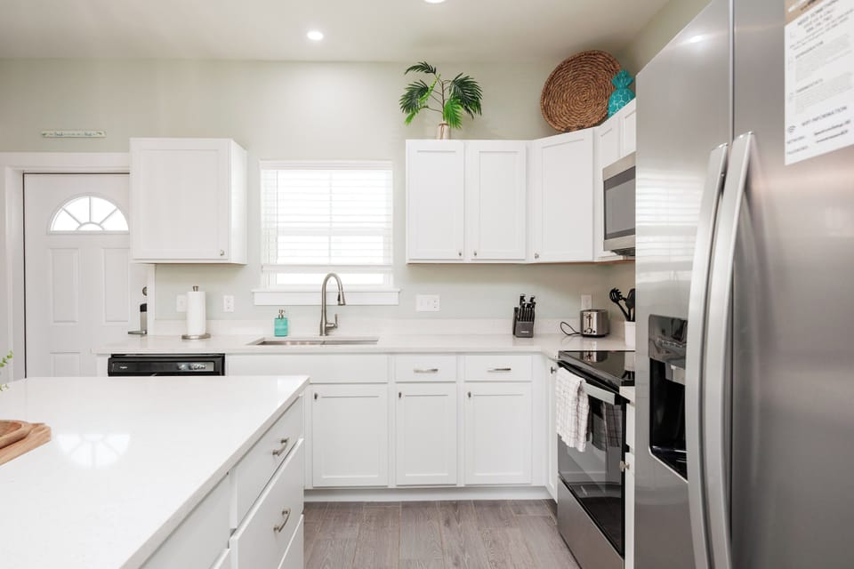 Your bright, fully-equipped kitchen invites culinary adventures with gleaming countertops, modern appliances, and charming touches that make cooking feel like home.